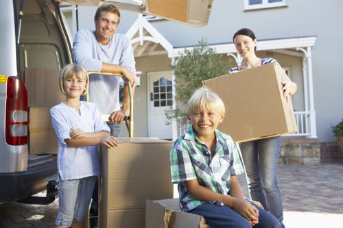 Driver and helper preparing items for transport in a removals van