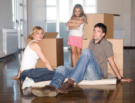Careful loading of boxed items into a van with secured straps